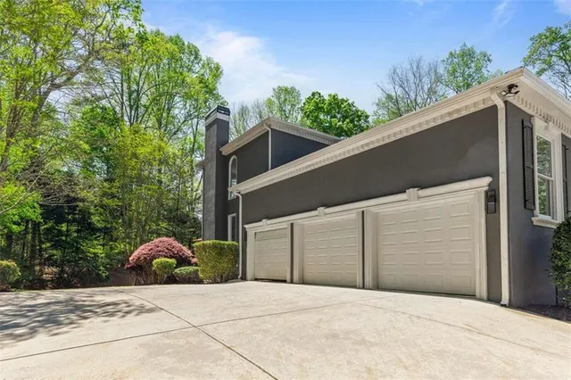 a view of a brick house with large windows