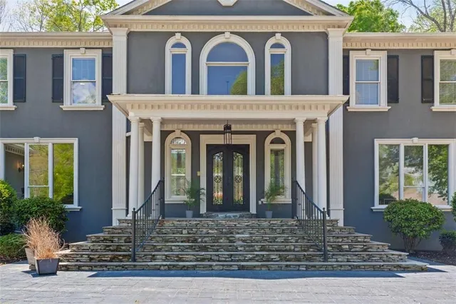 a front view of a house with a garden