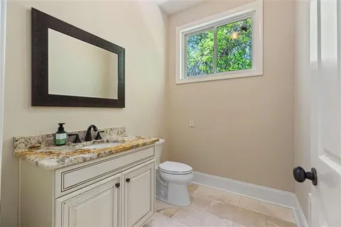 a kitchen with white cabinets and sink