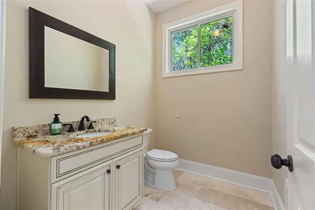 a kitchen with white cabinets and sink