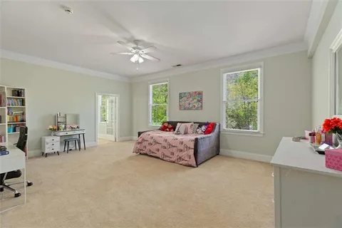 a view of a patio with table and chairs potted plants with floor to ceiling window