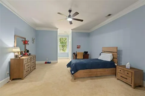 a view of a white house with large windows and a small yard