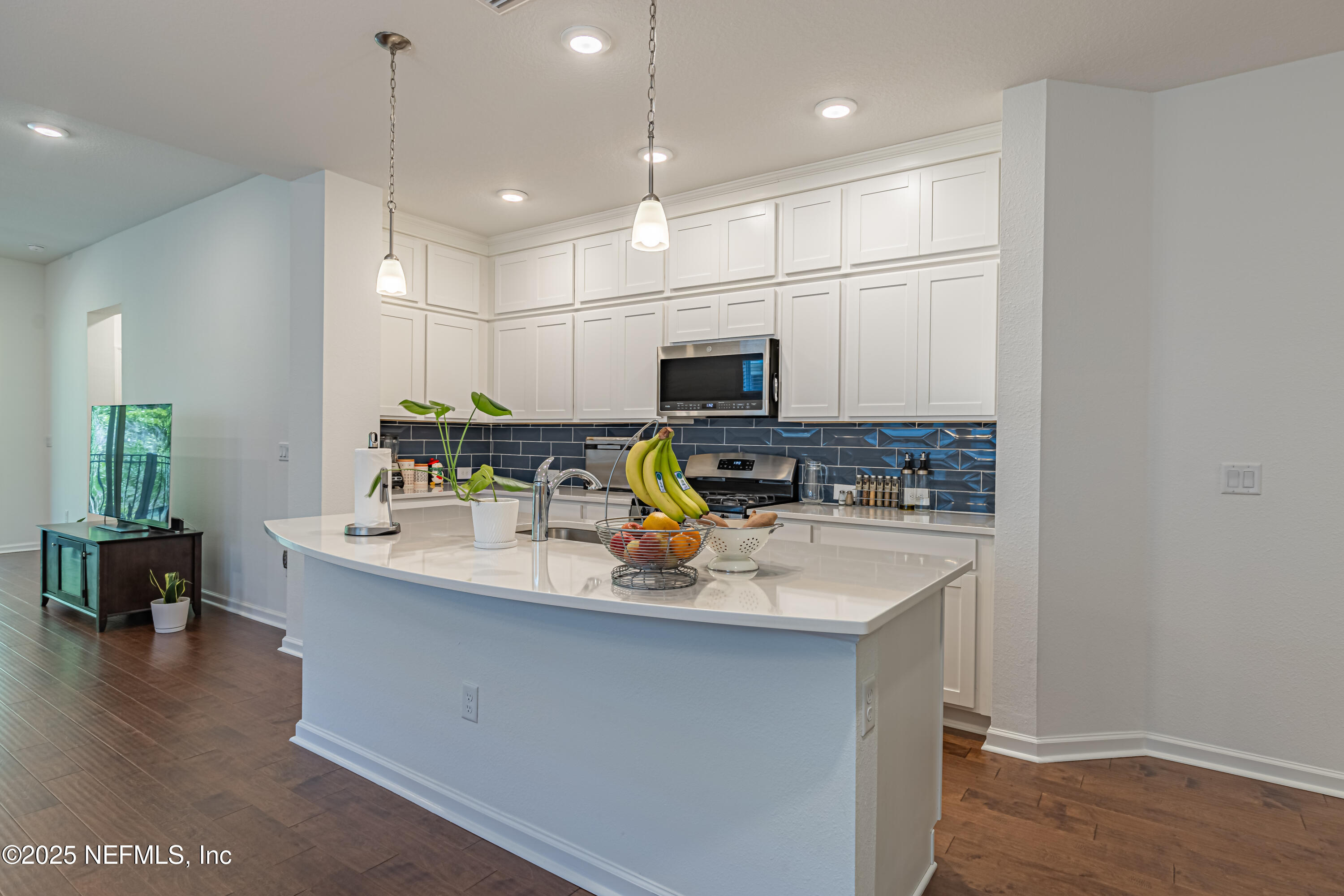 383 Windswept Way Street St. Augustine, FL 32092 - Photo 12 of 34 a kitchen with stainless steel appliances granite countertop a sink a stove and a wooden floors