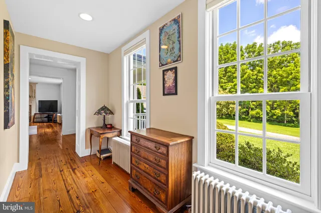 a bedroom with furniture and large windows