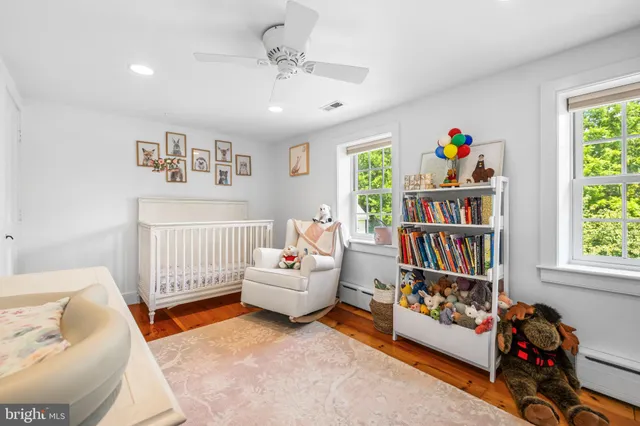 a living room with baby toys and a book shelf