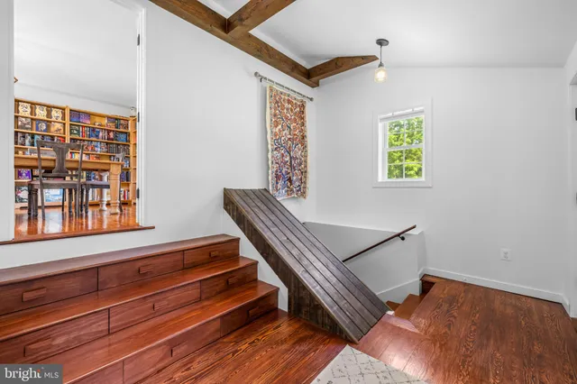 a view of room with window and wooden floor