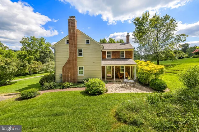 a aerial view of a house with a yard table and chairs