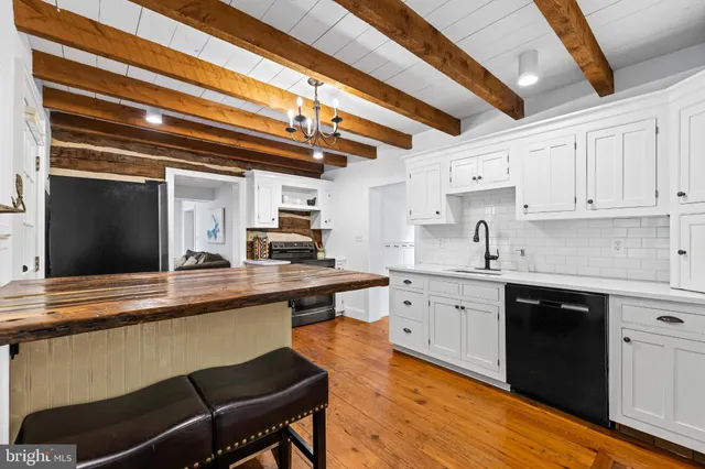 a kitchen with stainless steel appliances granite countertop a sink and cabinets