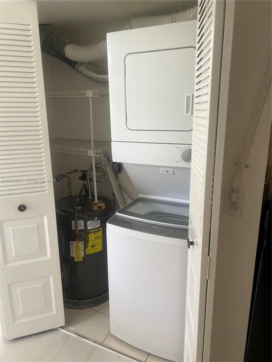 9510 Seagrape Drive, Unit 101 Davie, FL 33324 - Photo 14 of 18 a utility room with dryer and washer