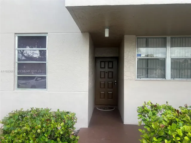 front view of a house with a potted plant