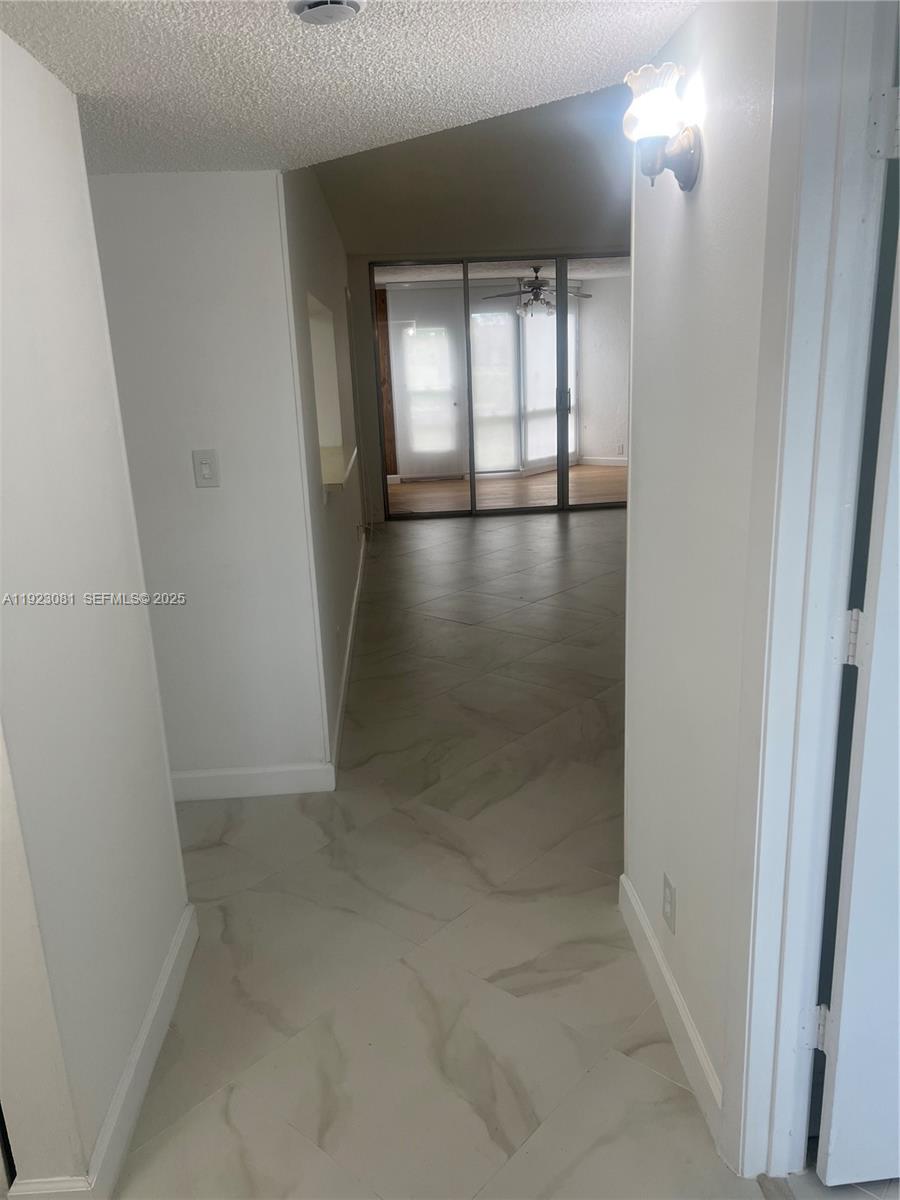 9510 Seagrape Drive, Unit 101 Davie, FL 33324 - Photo 7 of 18 an empty room with windows and closet