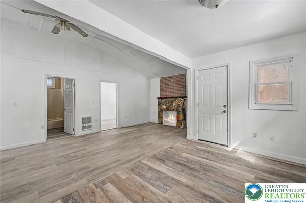 a view of empty room with wooden floor
