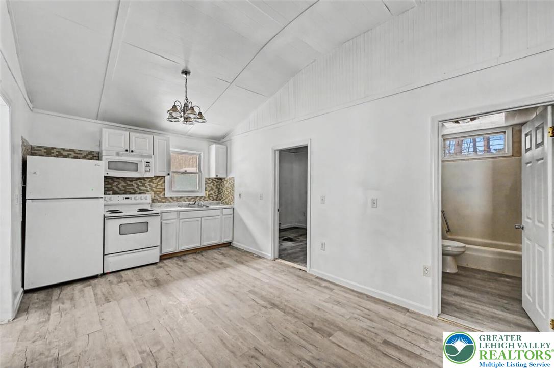 108 Mink Lane Bushkill, PA 18324 - Photo 19 of 33 a kitchen with stainless steel appliances a refrigerator sink and cabinets