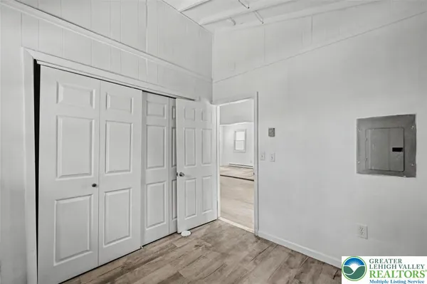 a kitchen with a refrigerator sink and white cabinets