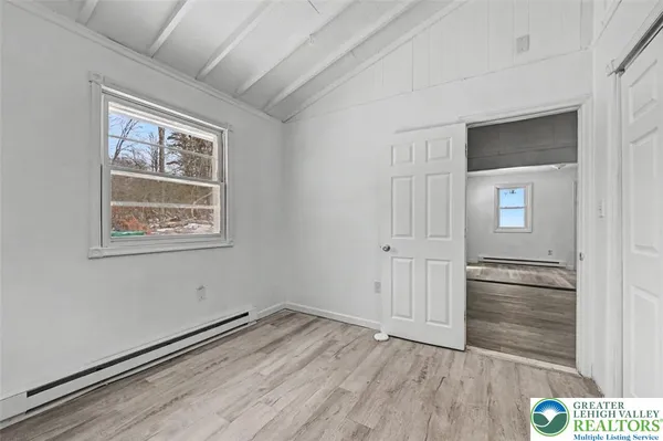 a view of an empty room with a ceiling fan