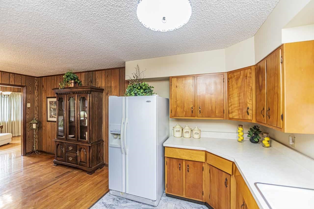 3285 Munford Giltedge Road Drummonds, TN 38023 - Photo 11 of 32 a kitchen with granite countertop wooden cabinets a refrigerator a sink and a stove