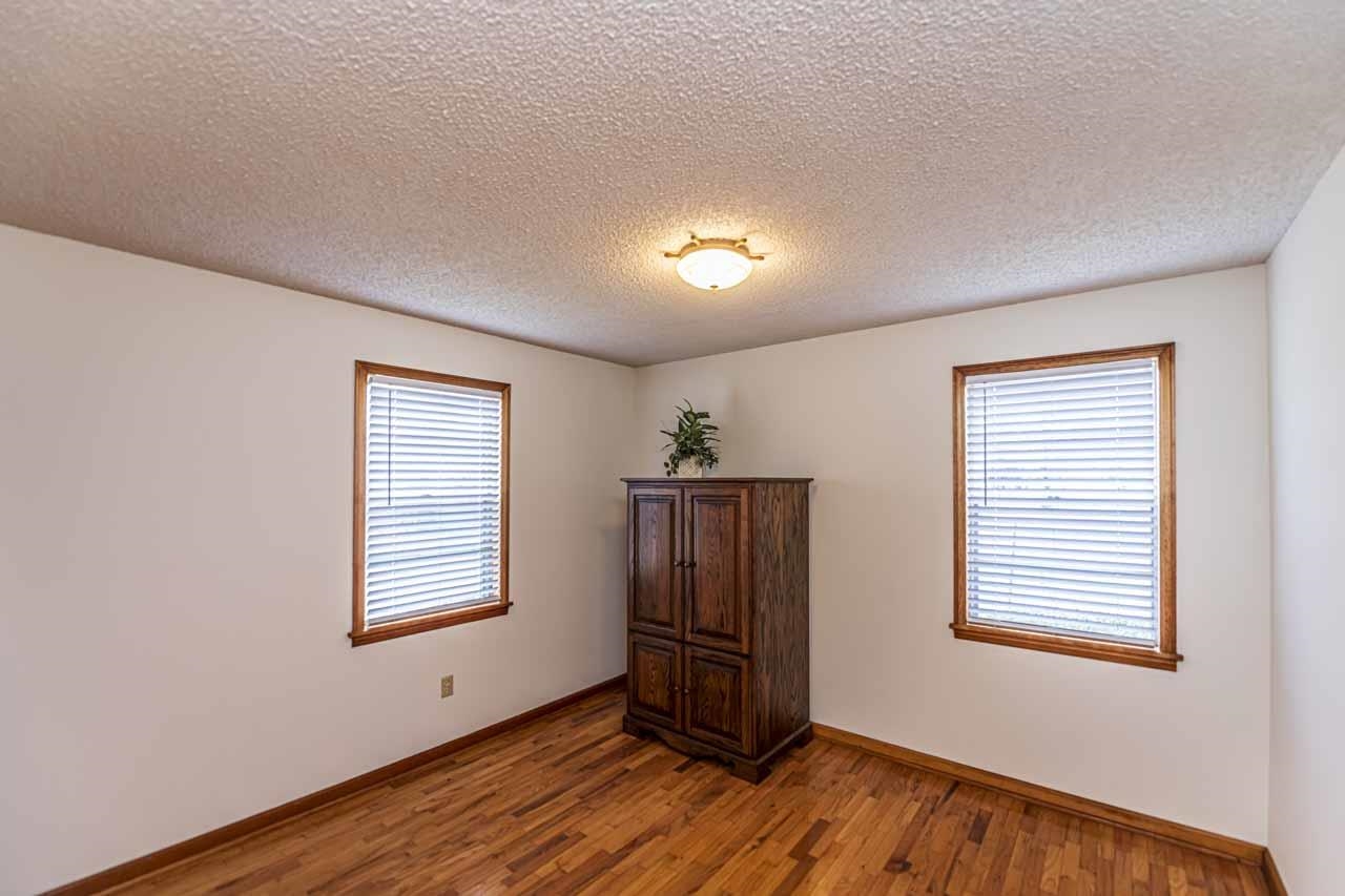 3285 Munford Giltedge Road Drummonds, TN 38023 - Photo 18 of 32 a view of an empty room with wooden floor and a window