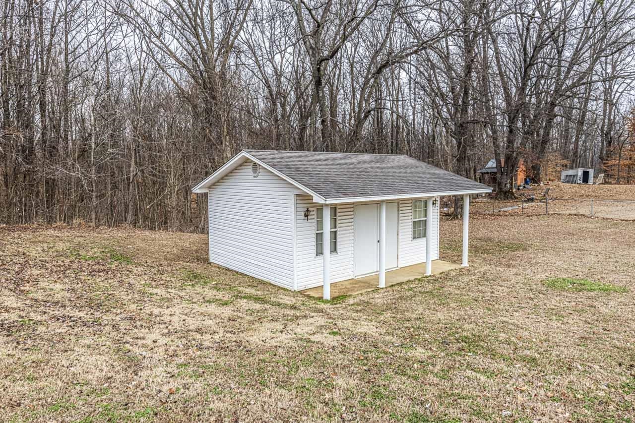 3285 Munford Giltedge Road Drummonds, TN 38023 - Photo 22 of 32 a view of a house with a yard and large trees