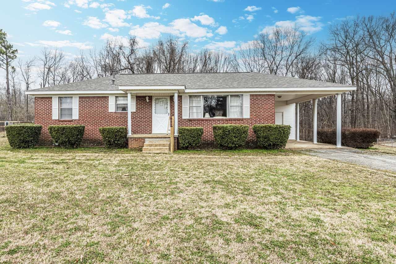 3285 Munford Giltedge Road Drummonds, TN 38023 - Photo 29 of 32 a front view of a house with garden