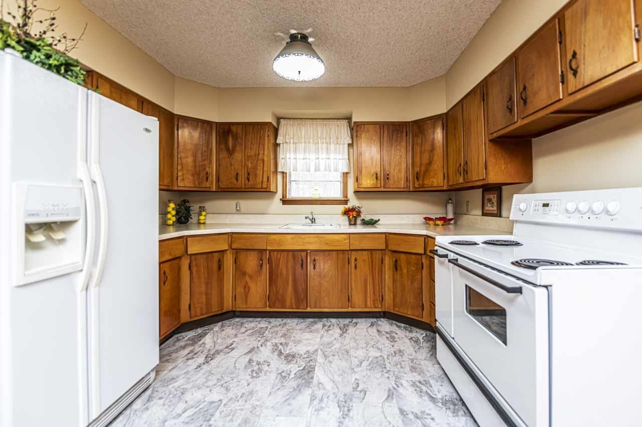 3285 Munford Giltedge Road Drummonds, TN 38023 - Photo 3 of 32 a kitchen with a stove sink and cabinets