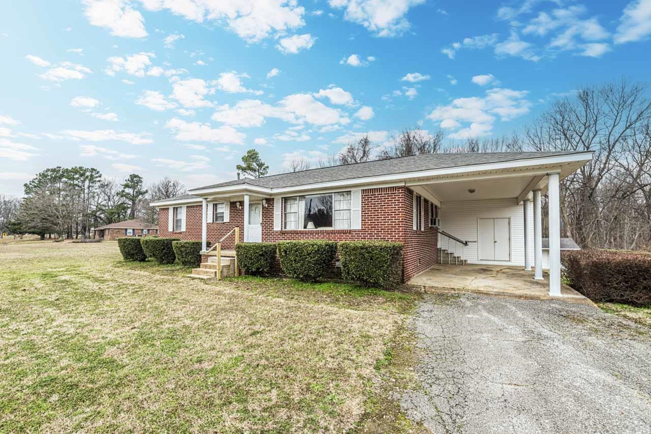 3285 Munford Giltedge Road Drummonds, TN 38023 - Photo 31 of 32 a front view of a house with a yard and garage