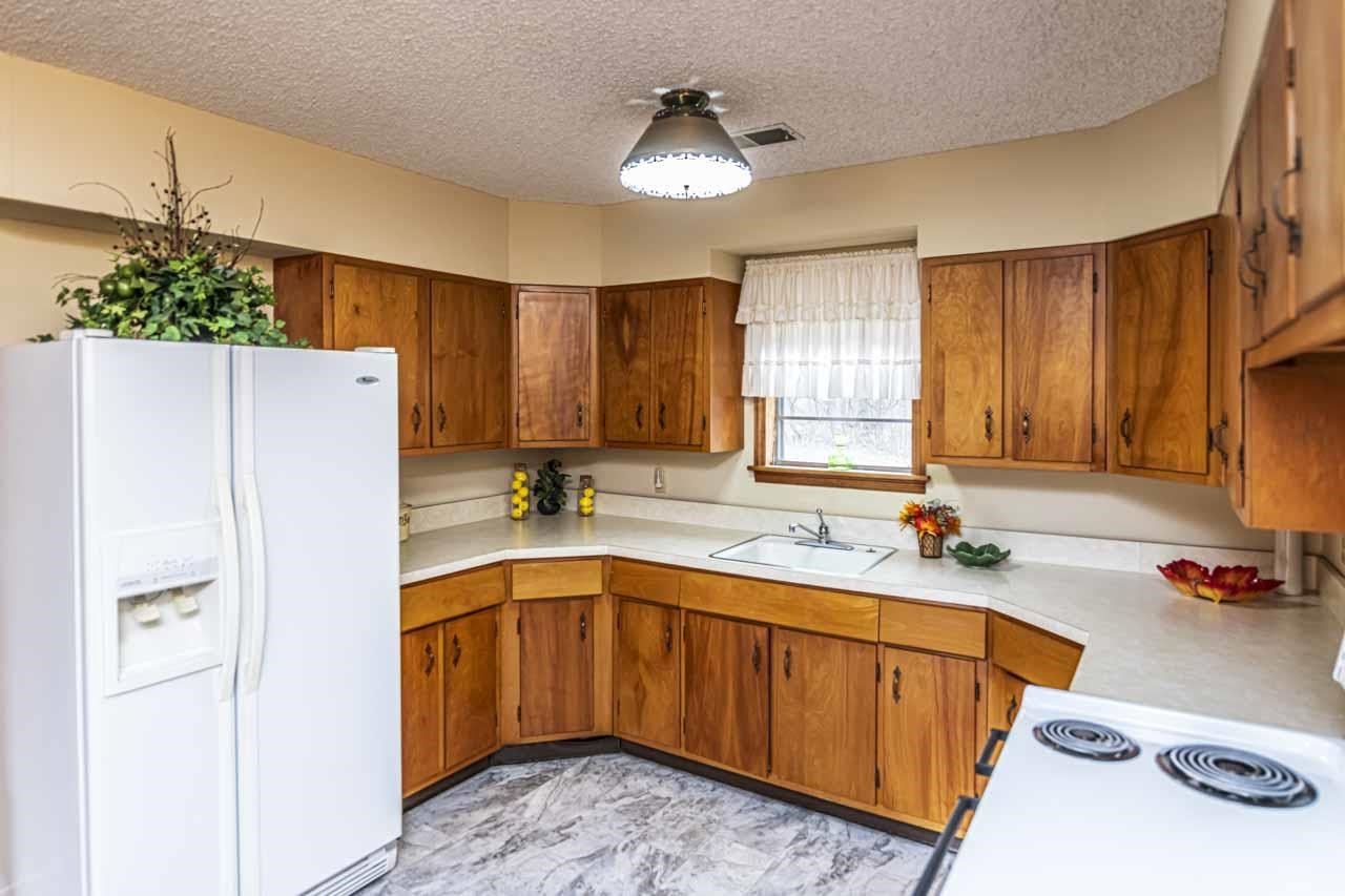 3285 Munford Giltedge Road Drummonds, TN 38023 - Photo 9 of 32 a kitchen with a sink refrigerator and cabinets