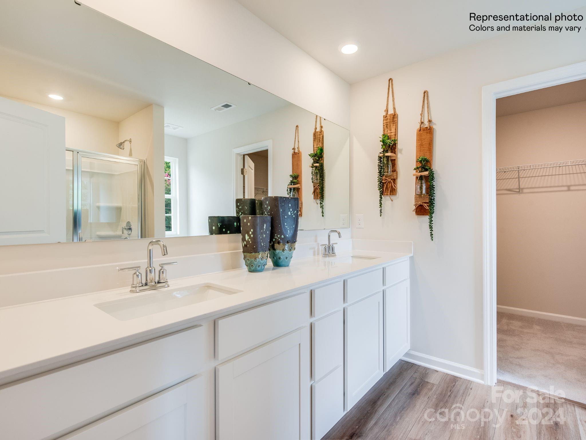 13228 Hampton Bay Lane Charlotte, NC 28262 - Photo 12 of 25 a bathroom with double vanity sink a mirror and a shower