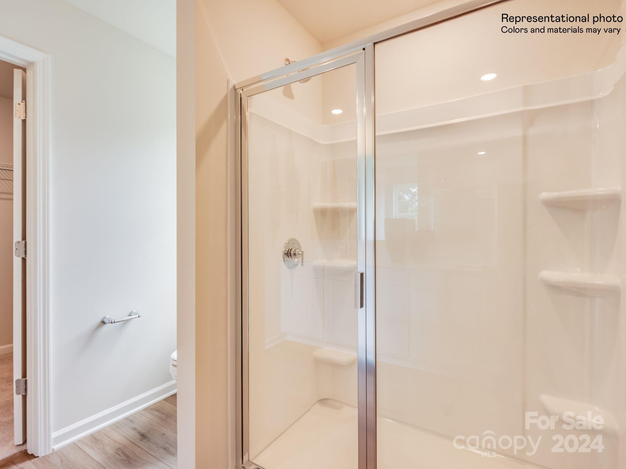 13228 Hampton Bay Lane Charlotte, NC 28262 - Photo 15 of 25 a bathroom with a glass shower door