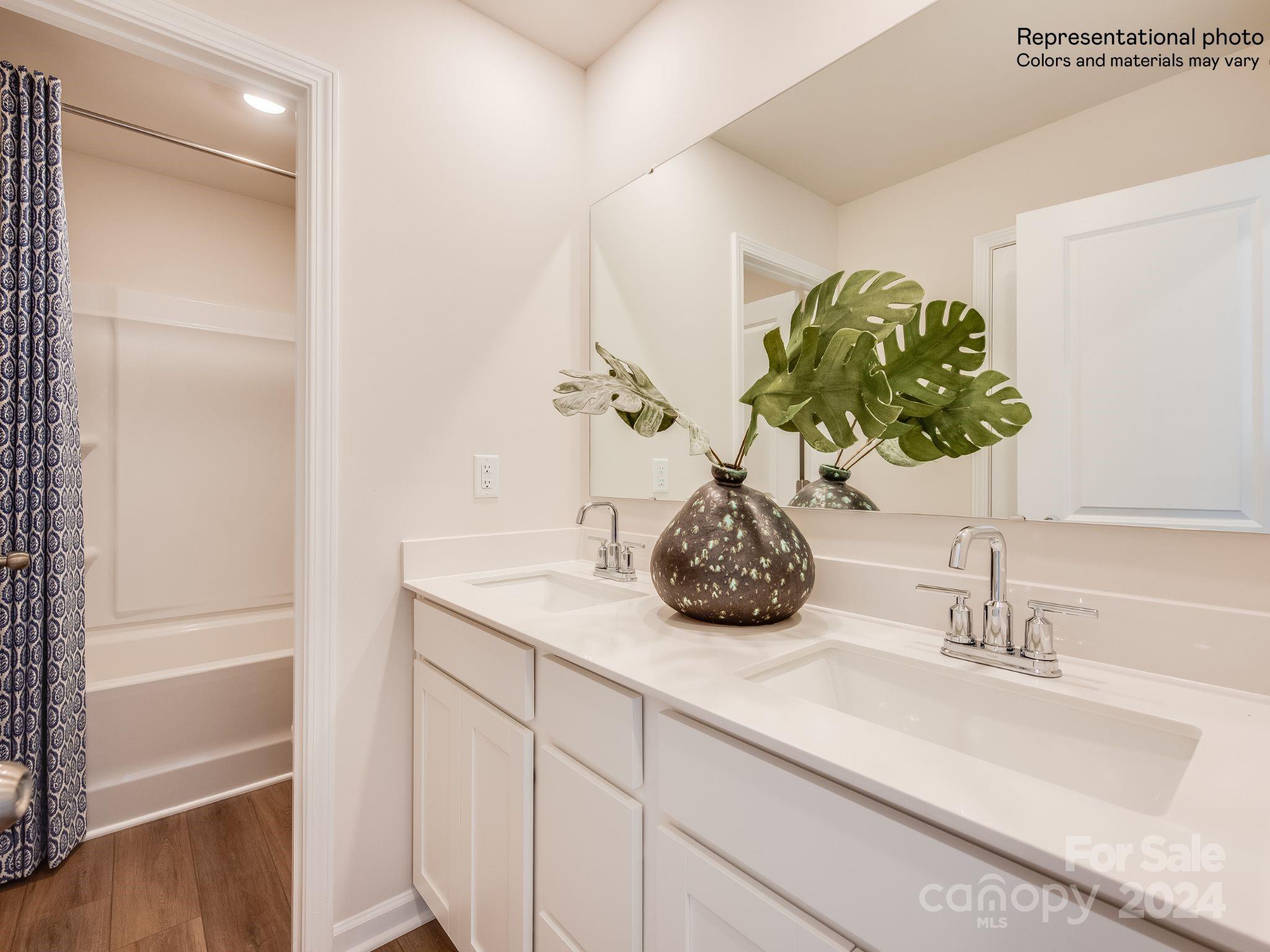 13228 Hampton Bay Lane Charlotte, NC 28262 - Photo 19 of 25 a bathroom with a sink and a mirror