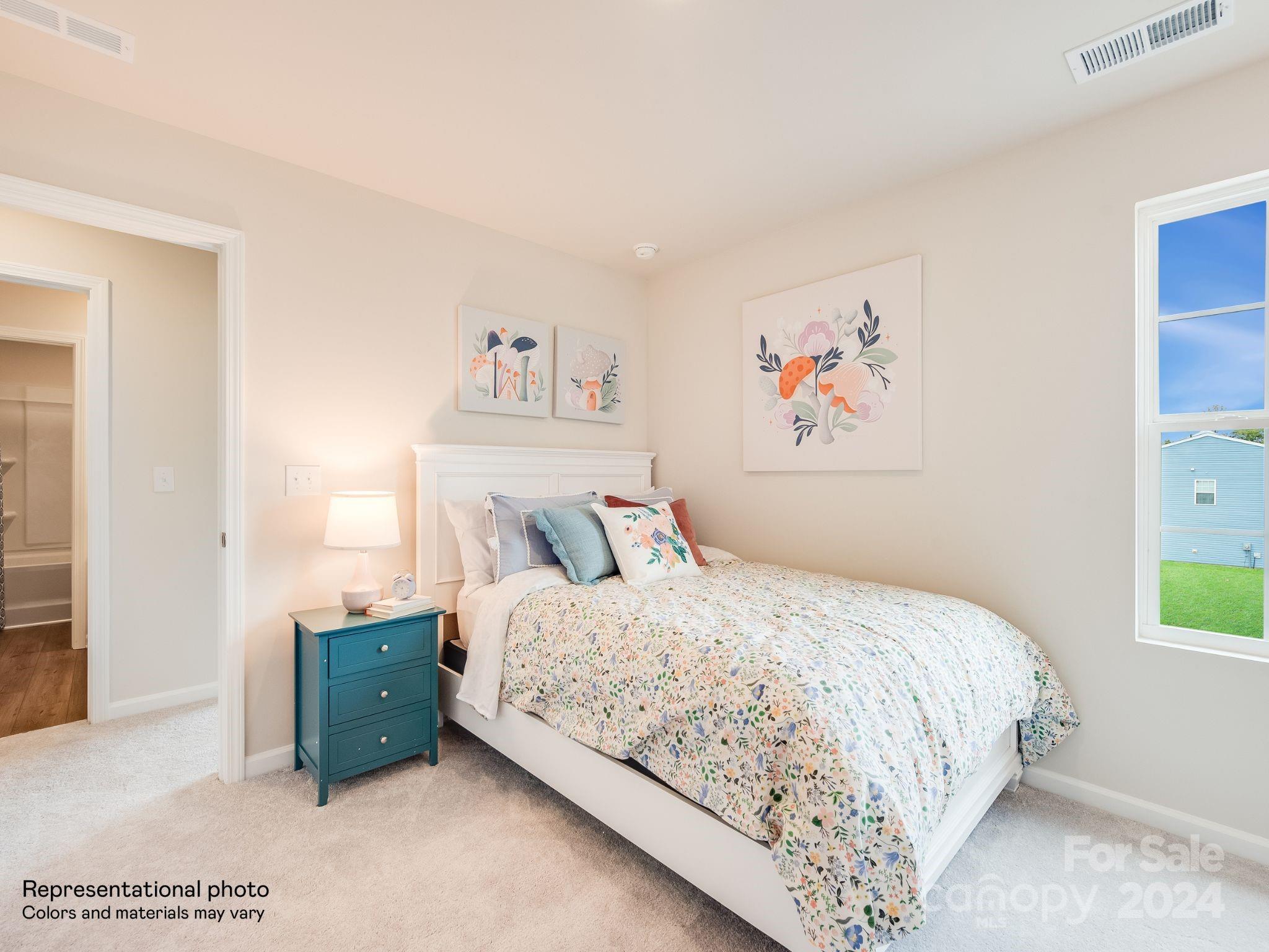 13228 Hampton Bay Lane Charlotte, NC 28262 - Photo 25 of 25 a bedroom with a bed and a painting on the wall