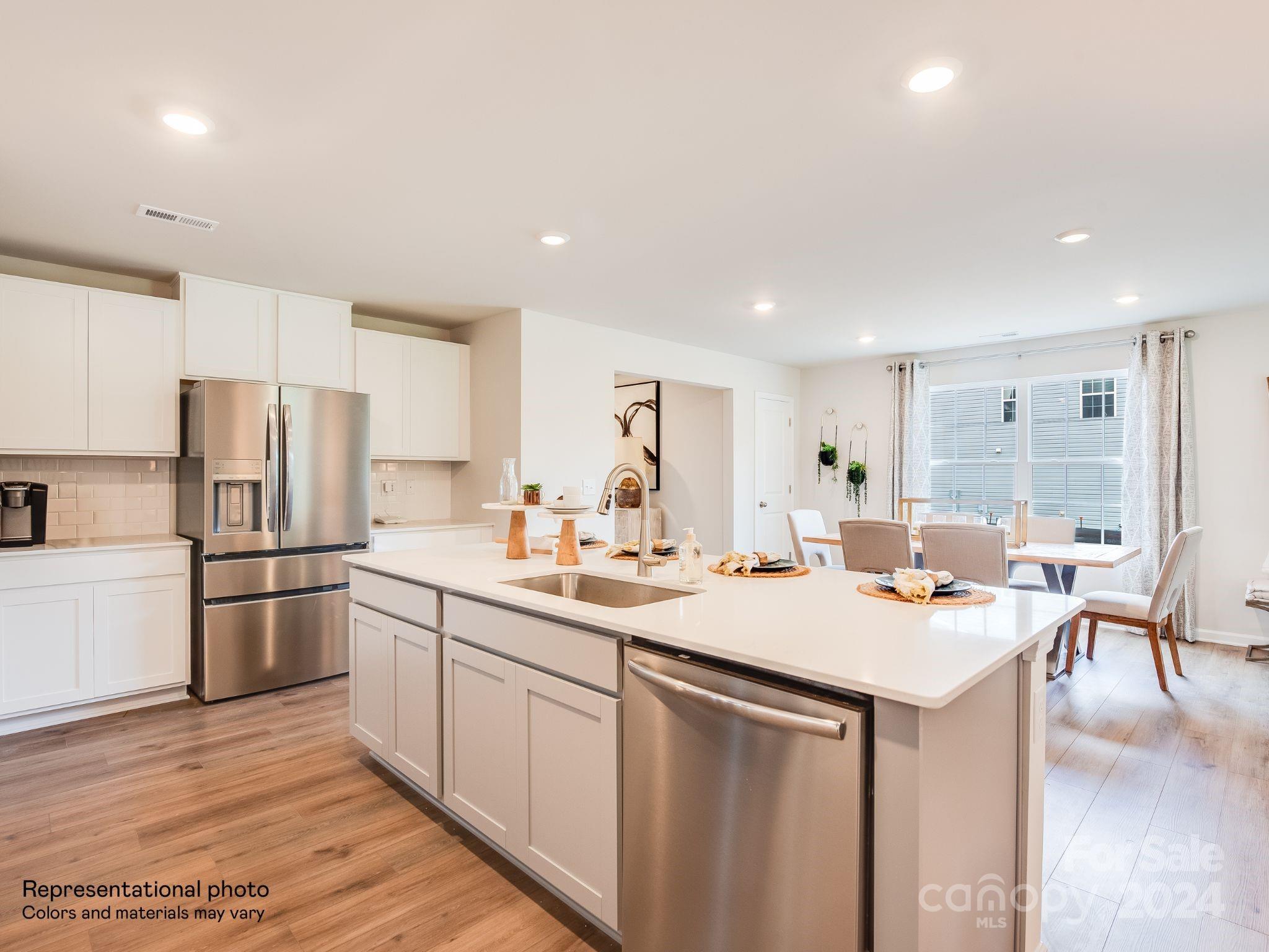 13228 Hampton Bay Lane Charlotte, NC 28262 - Photo 5 of 25 a kitchen with stainless steel appliances granite countertop a sink stove and refrigerator
