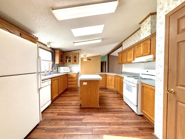 9 Swallow Lane Beecher, IL 60401 - Photo 11 of 20 a kitchen with stainless steel appliances granite countertop a refrigerator a sink dishwasher and a stove with wooden floor
