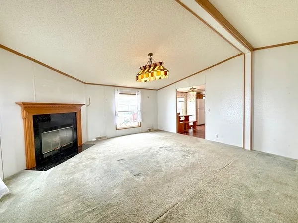 a view of empty room with a fireplace