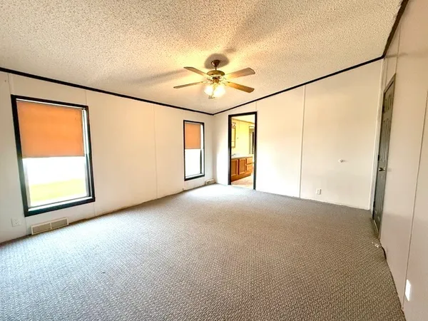 an empty room with windows and entrance