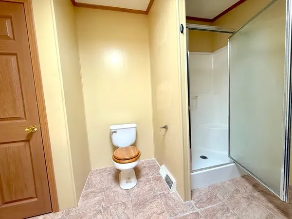 a bathroom with a toilet and a shower