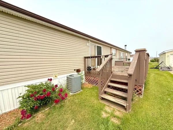 a view of a house with wooden floor and a fence