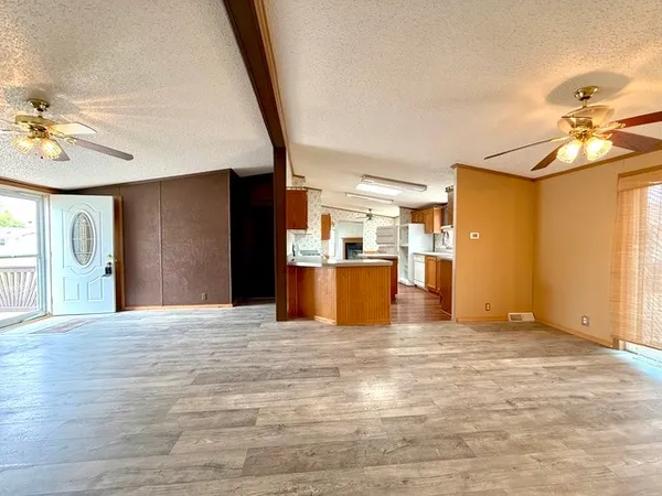 a view of a kitchen with a sink and a refrigerator
