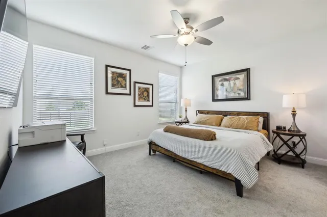 a spacious bedroom with a bed and a window