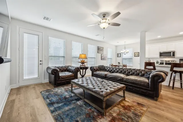 a living room with furniture ceiling fan and a rug