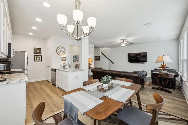 a view of a dining room with furniture and a chandelier