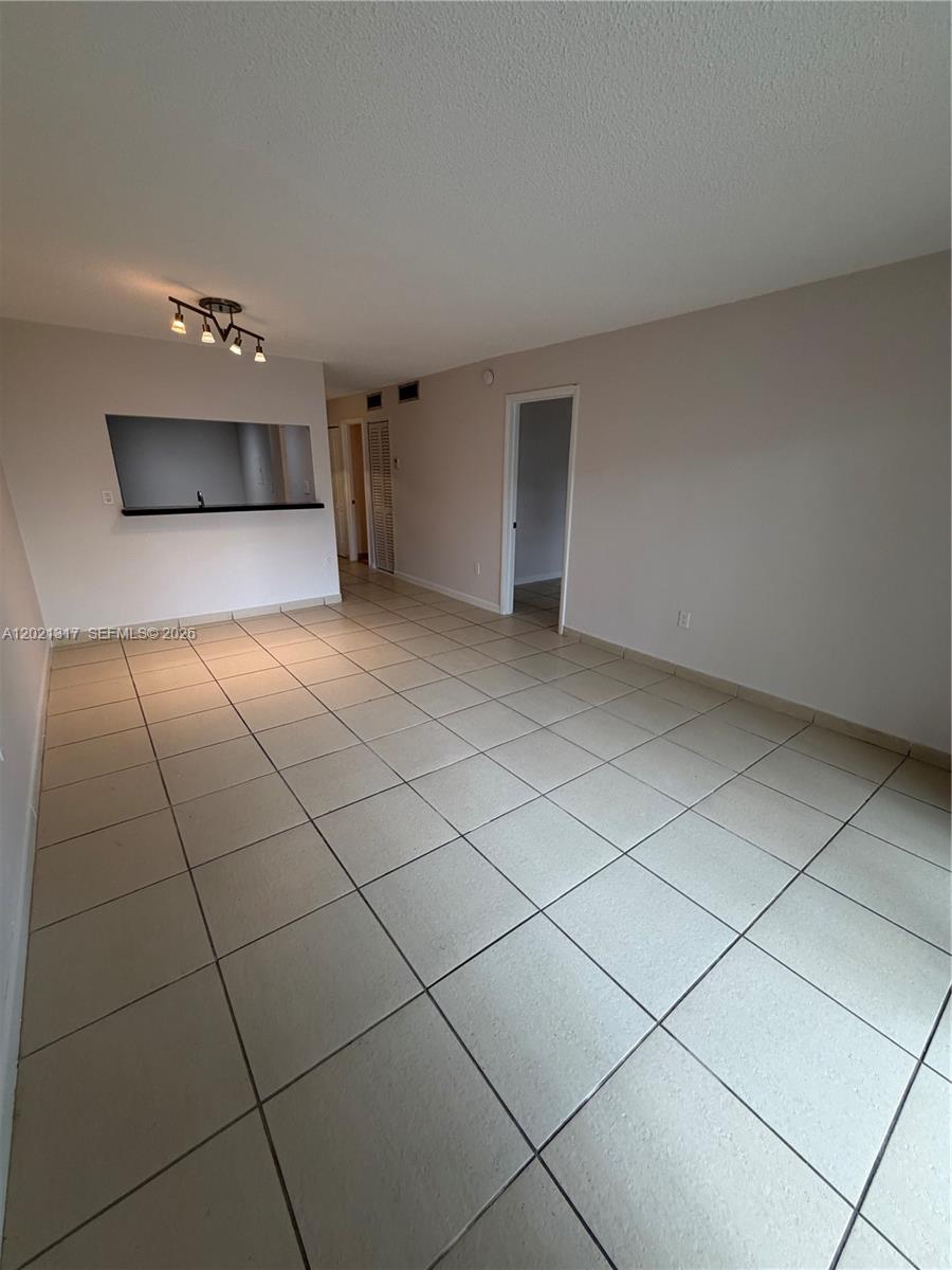 11201 Southwest 88th Street, Unit 102A Miami, FL 33173 - Photo 5 of 12 a view of a livingroom and an empty room