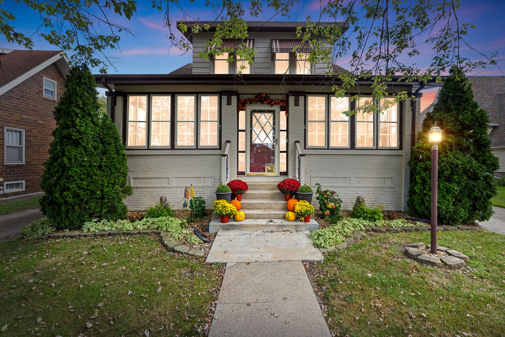 a view of a house with chairs in a yard