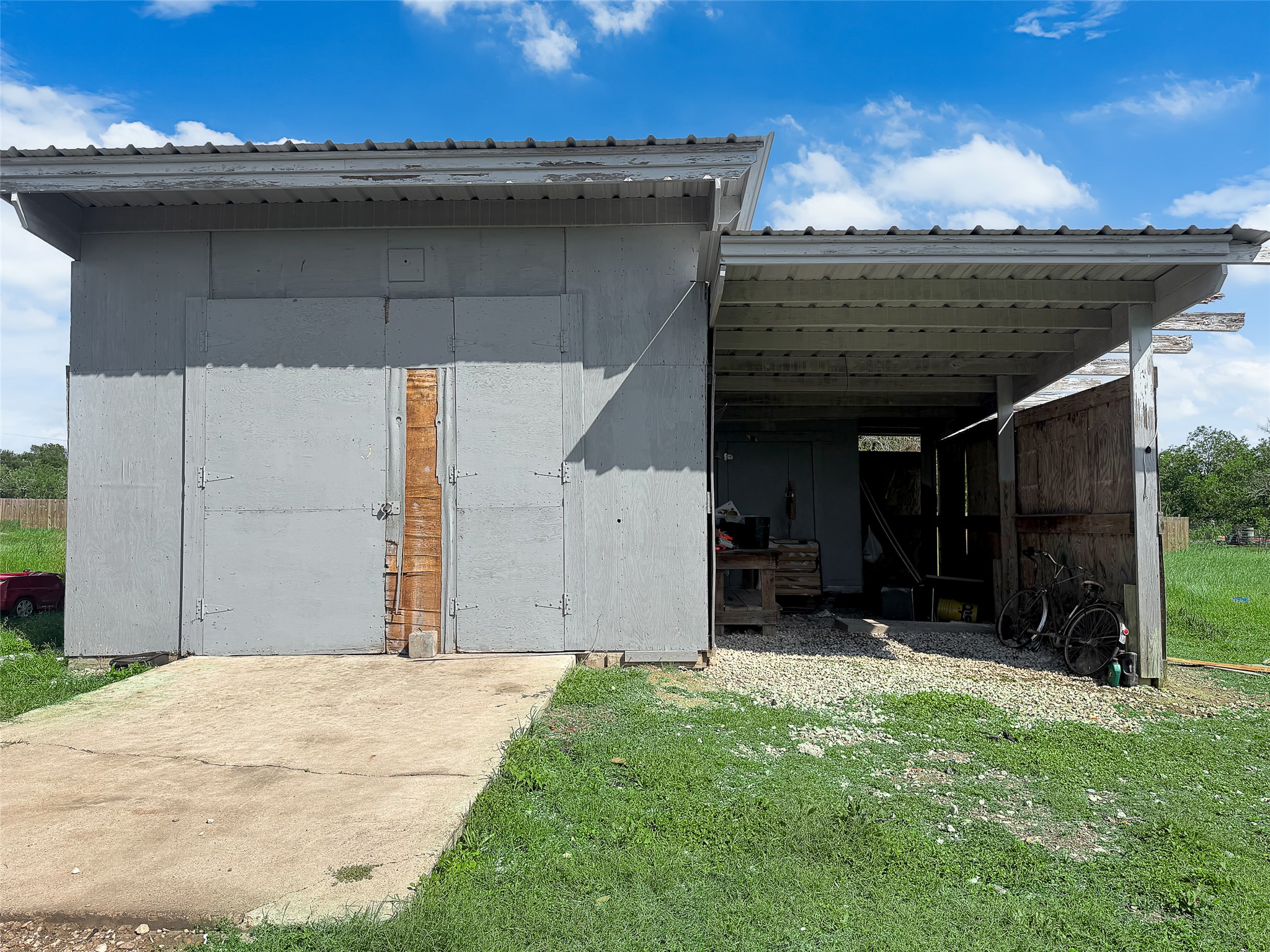 925 Long Hollow Road Dale, TX 78616 - Photo 23 of 26 Freestanding structure featuring a covered carport, concrete slab, and gravel parking area