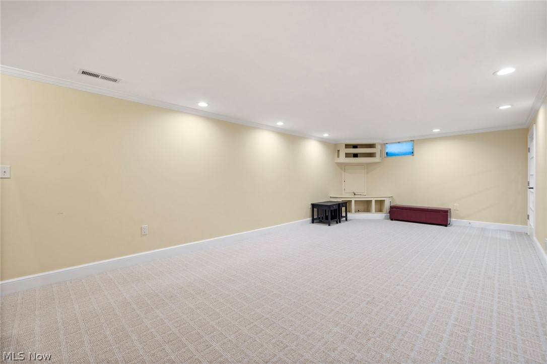 3871 Greentree Road Stow, OH 44224 - Photo 33 of 50 Spacious room featuring light-toned walls, recessed lighting, crown molding, patterned carpeting, and white baseboards