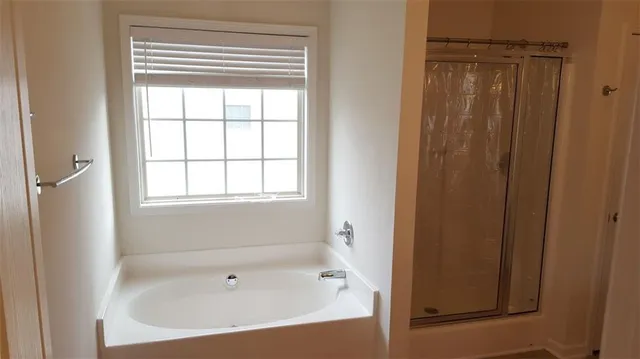 a white bath tub sitting next to a window