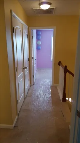 a view of a hallway with wooden shelves