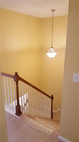 a view of stairs and hall with wooden floor