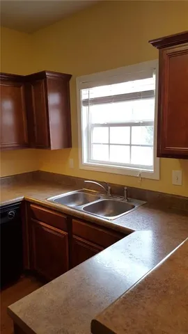 a kitchen with granite countertop cabinets and wooden floor