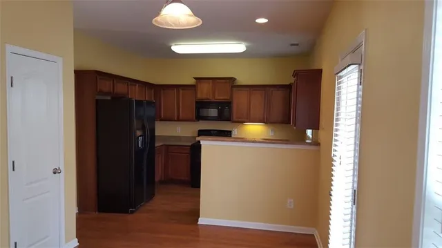 a kitchen with a refrigerator cabinet and a sink