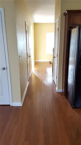 a view of a hallway with wooden floor